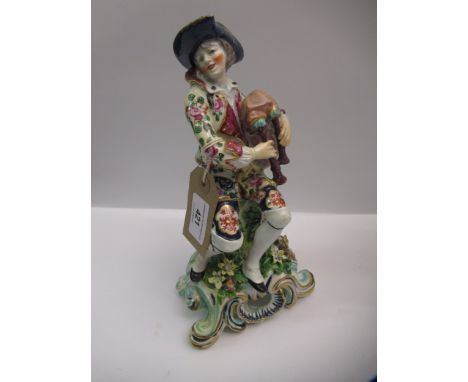 Samson Bow figure of a seated man playing bagpipes (restored), 24cm high