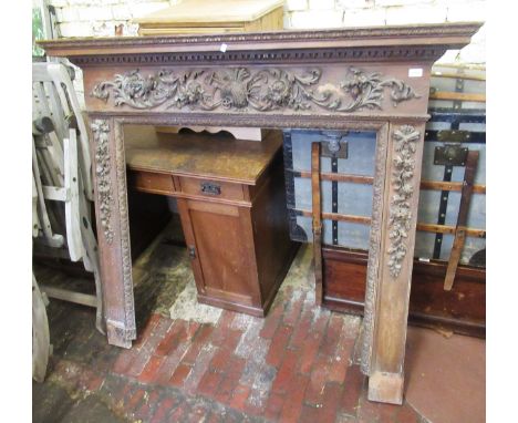 Early 20th Century stained pine and oak fireplace with applied bird, wheatsheaf and floral carvings, 149 x 131cmOverall dimen