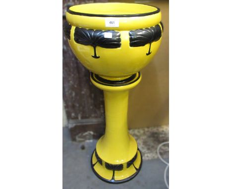 Bretby pottery jardiniere and stand of stylised Art Deco form with relief decoration on a yellow ground, 91cm high overall (d
