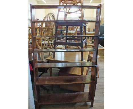 A Pine open seven shelf bookcase, a leather topped stool and two pine stools