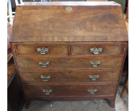A Georgian Mahogany bureau with inlaid and Satinwood veneered interior with two short and three long doors on bracket feet