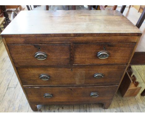 A 19th Century Oak chest of two short and two long drawers on bracket feet