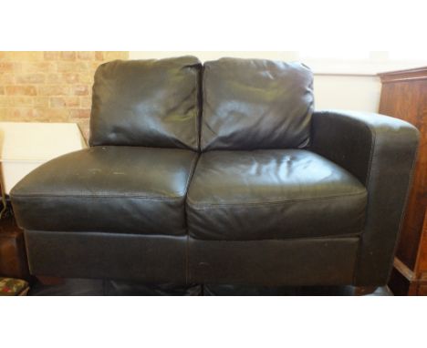 A dark brown leather corner sofa and matching foot stool