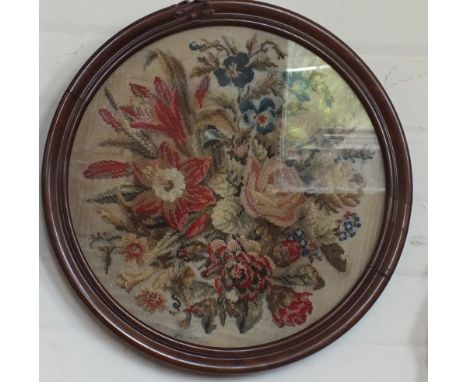 A circular Victorian floral tapestry picture and an inlaid Mahogany beaded top foot stool