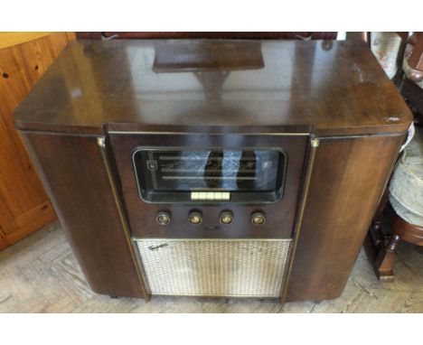 A 1950's Ferguson radiogram and records with a leaded light Brass frame firescreen