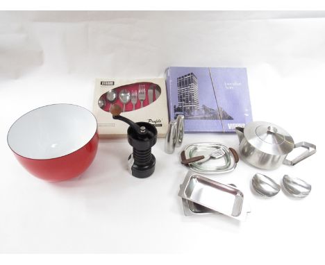 A red enamel metal bowl in the Krenit style, an Italian metal pepper grinder, two boxes of Vlners stainless steel cutlery, a 