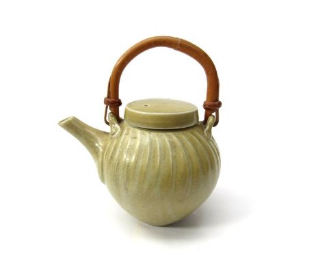 DAVID LEACH (1911-2005) A studio porcelain teapot, fluted cut sided top section with yellow celadon glaze, cane handle. Parti