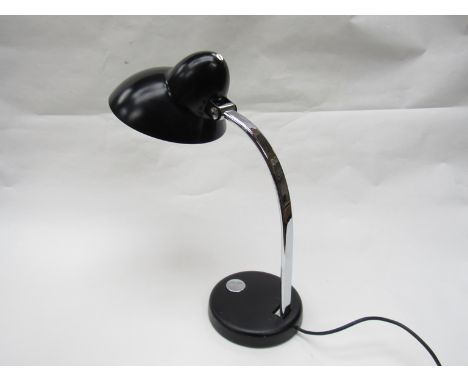 A table lamp with black painted metal down lighter and chromed metal adjustable arm