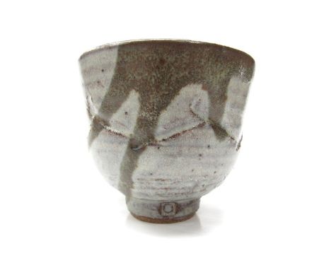 KENNETH QUICK (1931-1963) (ARR) A stoneware yunomi with ash glaze and slip over a cut line body. Partially filled in personal