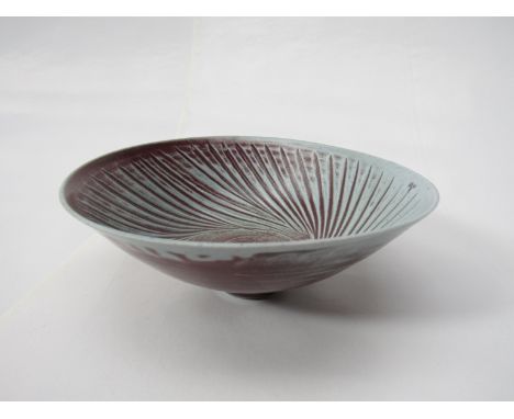 MARIANNE DE TREY (1913-2016) A studio porcelain bowl with spiral cut interior, partially covered in red glaze over blue. Impr