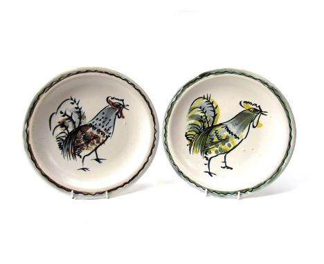 MARIANNE DE TREY (1913-2016) Two studio pottery utility range plates painted with a cockerel. Impressed shell seal. 25.5cm di