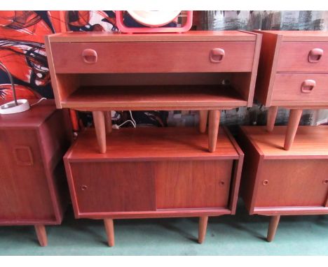 A pair of Danish teak low cabinets, single drawer and open shelf plus twin sliding doors raised on tapering legs. Largest 80c