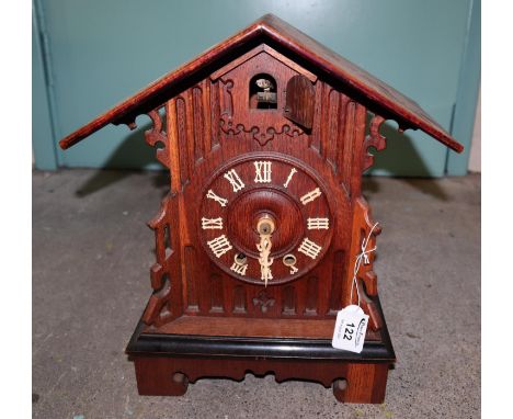 Black forest type oak cuckoo clock of architectural form. 35cm high approx. (B.P. 21% + VAT) Drum movement, mechanical, no we