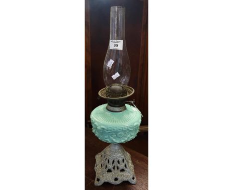 Early 20th Century double oil burner lamp with clear glass chimney, turquoise reservoir with rams head mounts on a pierced ca