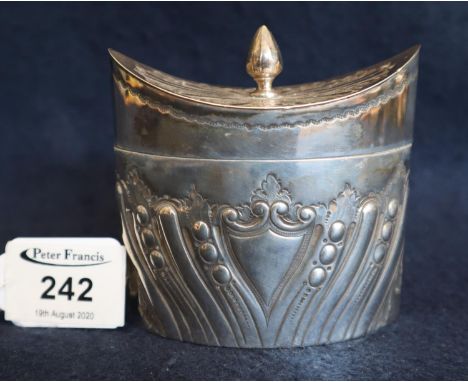 Small silver boat shaped repousse decorated tea caddy with hinged cover (hinge broken). Sheffield hallmarks, 4.8 troy ozs app