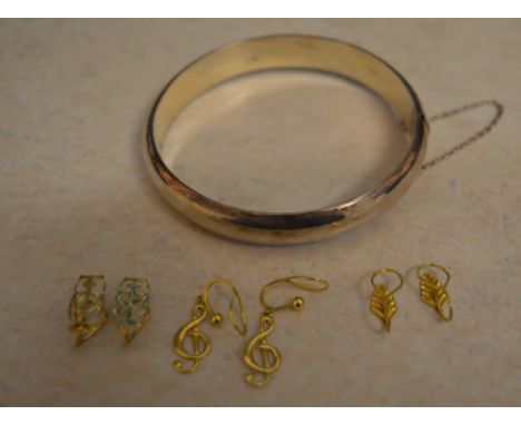 3 pairs of 9ct gold slip on earrings and a silver bangle