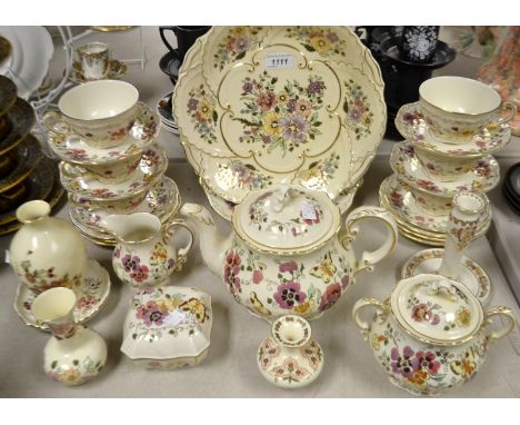 A Zsolnay Hungary floral tea service for six, comprising large cake plate, side plates, teapot, bread and butter plate, etc.;