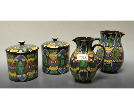 A late 19th century Majolica Thoune Owl design pitcher signed W Heimberg; another smaller; a pair of storage jars (4)