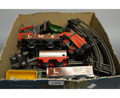 Hornby O gauge - a lock work 0-4-0 locomotive and four wheel tender, red and black livery, numbered 3435; two LMS goods wagon