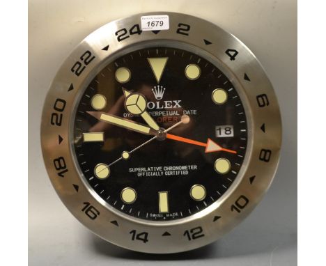 A Rolex circular wall clock, luminous baton markers, Arabic numerals, quartz movement, 23.5cm 