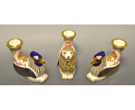 A Royal Crown Derby candle holder, griffin, first quality; another, similar, first quality; another, a lion, second quality (