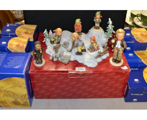A Goebel figure Hello Chef, boxed; others, Ice Hockey players, boxed; a winter landscape stand; a mountain climber; qty (9)