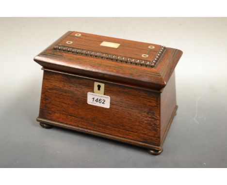 A William IV rosewood sarcophagus tea caddy, inlaid with mother of pearl cartouche and roundels bun feet, c.1835