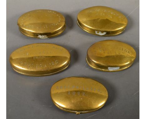 A Victorian brass oval miner's snuff box, the cover inscribed Levi Philips 1877, push-botton, 6.5cm wide, c. 1875; others sim