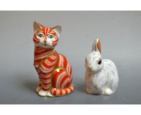 A Royal Crown Derby paperweight, snowy rabbit, first quality; another, ginger tom, second quality, unboxed (2)