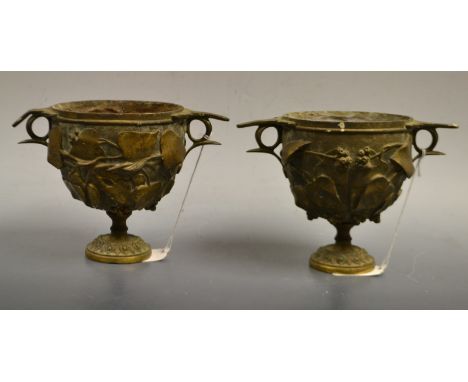 A pair of French patinated Grecian two-handled wine cups or skyphos, boldly cast with vine, spreading circular foot, 12cm hig