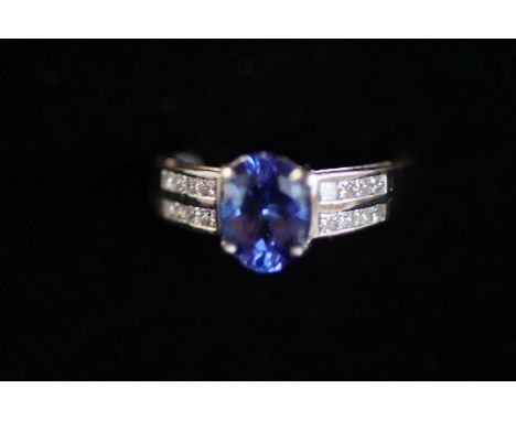 18ct White gold ring set with 16 princess cut diamonds &amp;   large blue tanzanite stone Size N.5