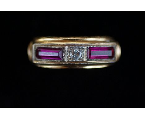 Diamond &amp; ruby ring set in yellow metal tested for gold, central diamond with 1 ruby either side. Diamond approx. 3/16 ca