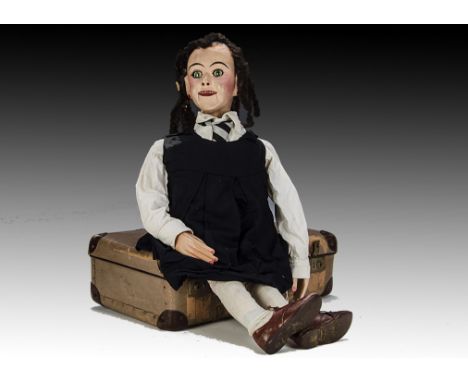 Sally Anne, a ventriloquist school girl dummy, with papier-mâché head, mechanism for moving eyes and mouth, wood hands and fe