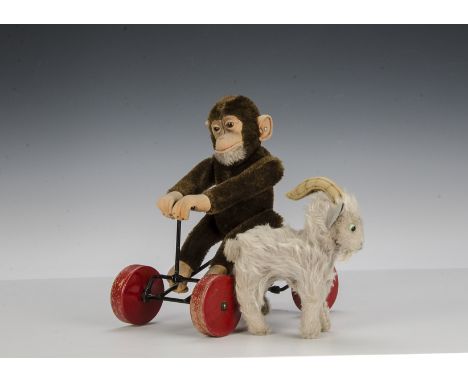 A Steiff Record-Peter 1950s, with brown mohair, script button and red wooden wheeled metal framed carriage - 10in. (25cm.) hi