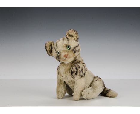 A Steiff jointed tabby cat, probably 1930s, grey with black marking mohair, replace glass eyes, pink stitched nose, mouth and
