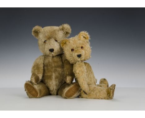 Two post-war Chiltern teddy bears: a blonde Hugmee with orange and black glass eyes, black stitched nose and mouth, swivel he