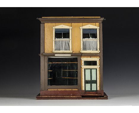 No.7 Elsie Mountjoy, a home built collapsable toy shop dolls’ house, with two storeys, the front with large shop window and o