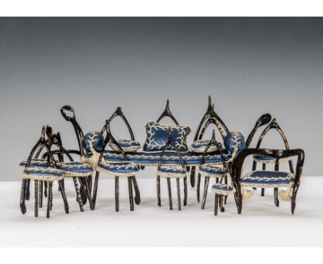 Twelve pieces of late 19th century wishbone furniture, painted brown, upholstered in blue with white stitch work including so