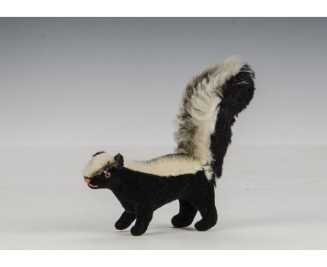 A rare Steiff skunk, 1962-63, with short mohair back, black velvet body and longer mohair tail - 41?2in. (11.5cm.) long