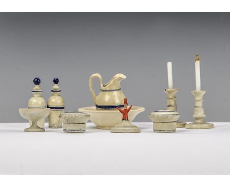 A German turned wood and painted dolls’ house dressing table set, comprising a pair of candlesticks, scent bottles with stopp