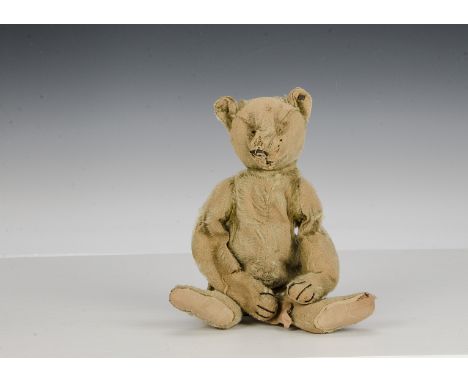 An early Steiff teddy bear, circa 1909, with blonde mohair, pronounce muzzle, black stitching, swivel head, jointed elongated