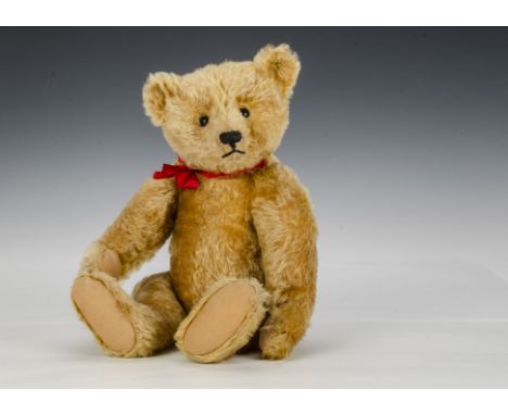 A fine and rare Steiff centre-seam teddy bear, circa 1912, with golden mohair, black boot button eyes, pronounced clipped muz