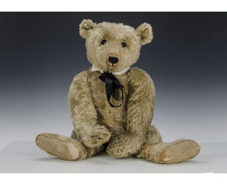 A large early Steiff Teddy Bear circa 1910, with blonde mohair, black boot button eyes, pronounced clipped muzzle, black stit