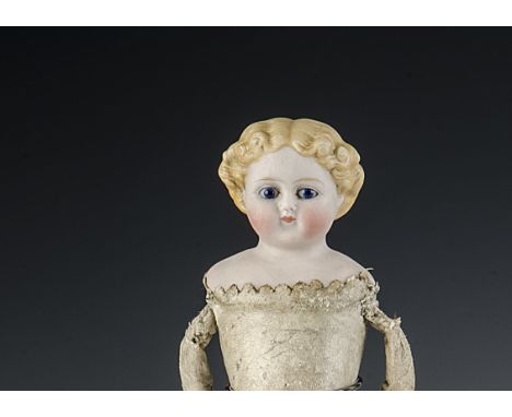 A small Kling type shoulder-head doll, with fixed dark blue eyes, blonde painted moulded hair in curls with central parting, 