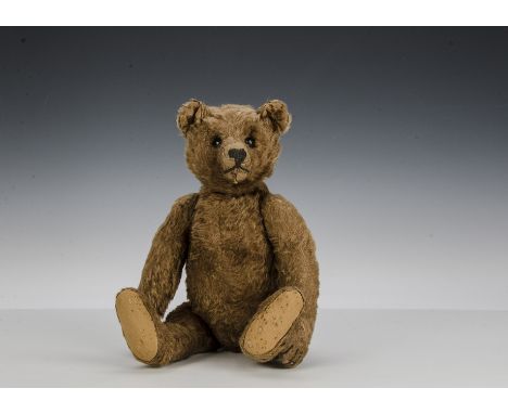 A rare early Steiff brown mohair teddy bear, circa 1910, with black boot button eyes, pronounced clipped muzzle, black stitch