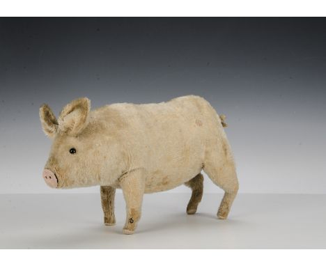 A rare Steiff Squeak Pig, 1910-20s, with pink mohair, black boot button eyes, forward facing ears, curly tail and grunting me