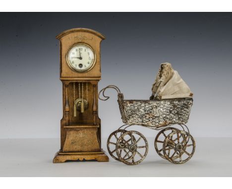A doll size long case clock, with enamel dial, Art Noveau carved detail and sun pendulum - 101?4in. (26cm.) high; and a paint