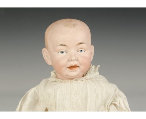 A German bisque headed character baby, similar to the Kaiser baby with blue intaglio eyes, open/closed mouth, painted blonde 
