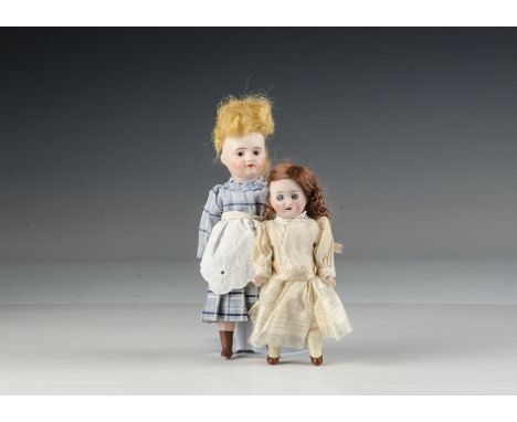 Two small bisque headed dolls: a doll marked M with blue sleeping eyes, brown mohair wig, straight legged composition body an