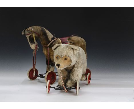 A Steiff post-war Young Riding Bear, one red metal wheels with white tyres, pull growler and script button in ear - 251?2in. 